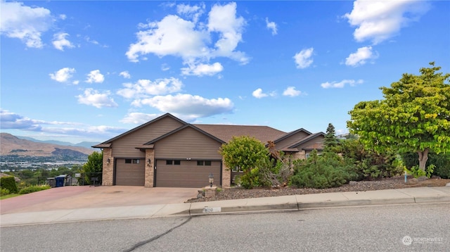 view of front of home with a garage and a mountain view