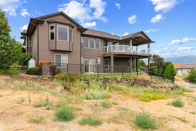 rear view of property featuring a balcony