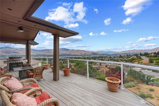 deck with grilling area and a mountain view