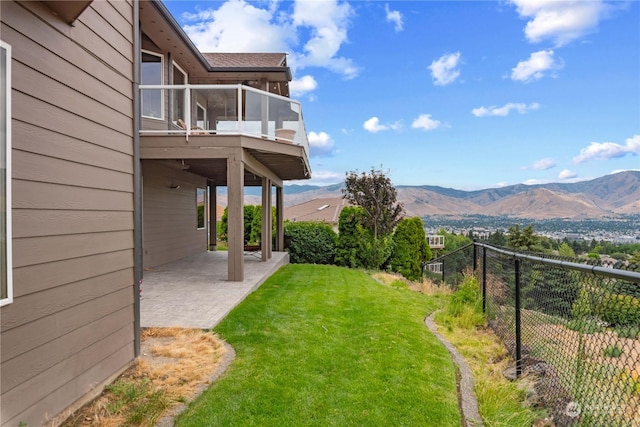 view of yard with a sunroom, a mountain view, and a patio area