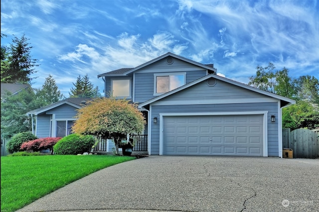 view of front of property featuring a garage and a front lawn