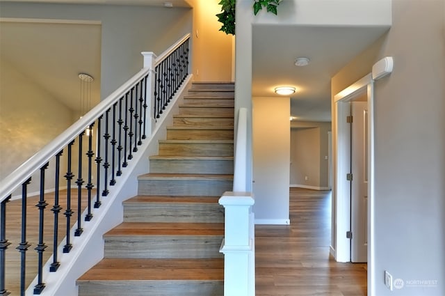 stairs featuring wood-type flooring