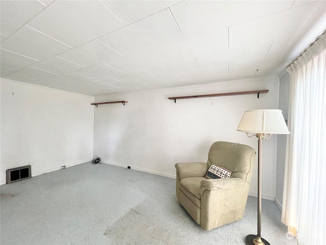 sitting room featuring light colored carpet