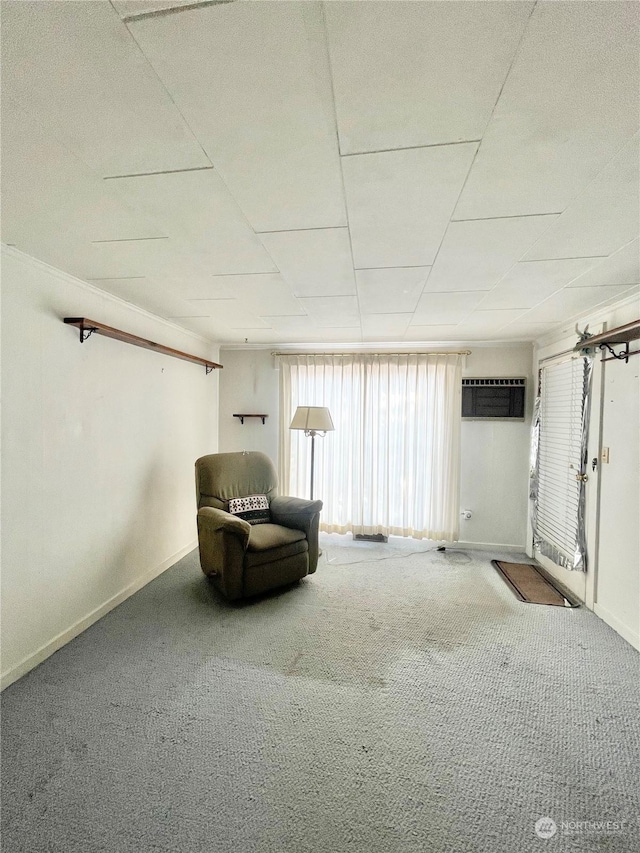 unfurnished room with a wall mounted AC and carpet