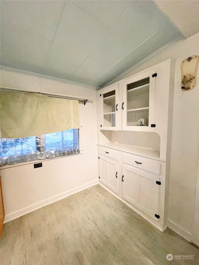 bathroom with hardwood / wood-style flooring and vaulted ceiling