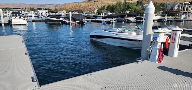 view of dock with a water and mountain view