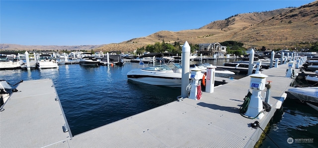 view of dock with a water and mountain view