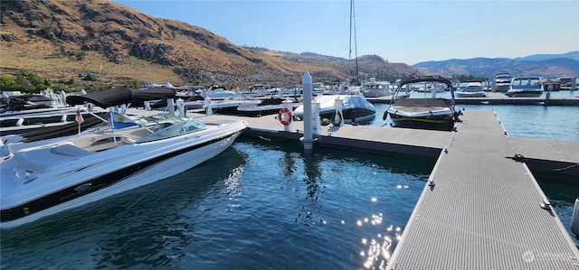 view of dock with a water and mountain view