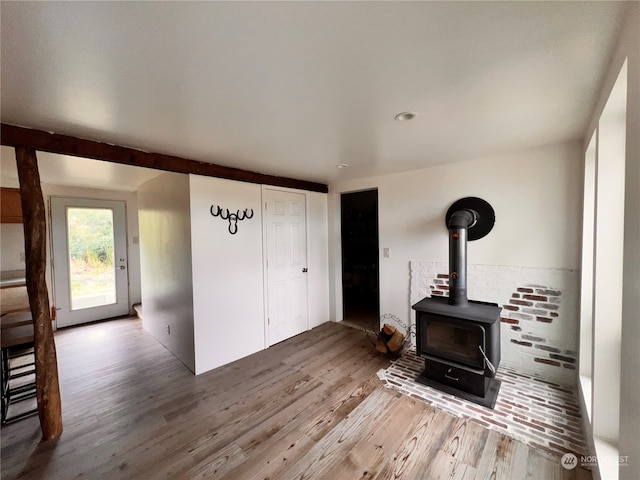 living room with wood-type flooring and a wood stove