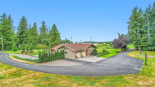 view of community featuring a yard and a detached garage