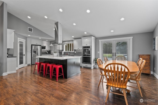 dining area featuring lofted ceiling, french doors, dark wood-type flooring, and visible vents