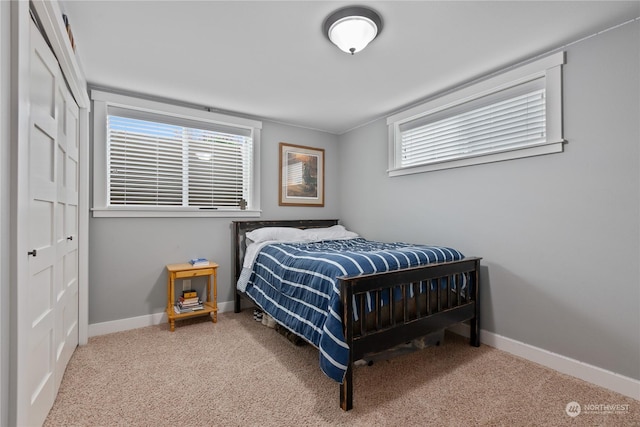 bedroom with a closet, baseboards, and carpet flooring