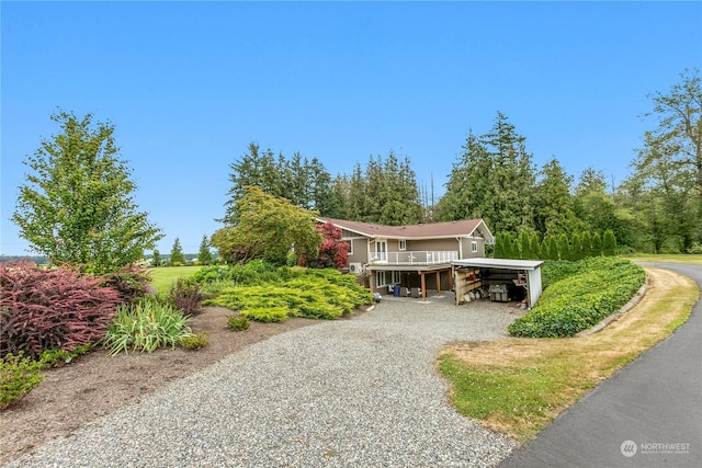 view of front of home with driveway and a carport