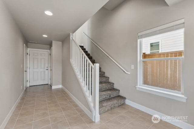 stairs featuring light tile patterned floors