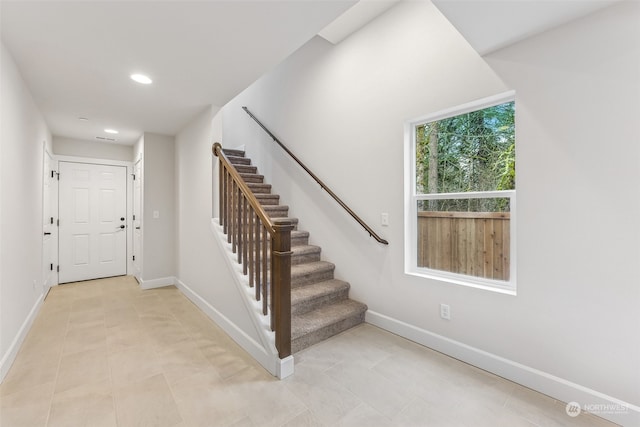 staircase featuring tile patterned floors