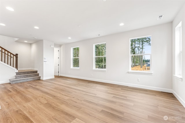 unfurnished living room featuring a healthy amount of sunlight and light wood-type flooring