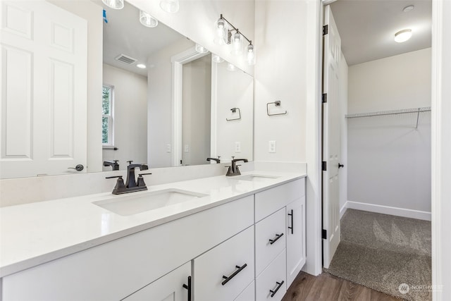 bathroom featuring hardwood / wood-style flooring and vanity