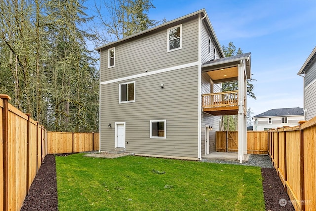 rear view of property featuring a yard