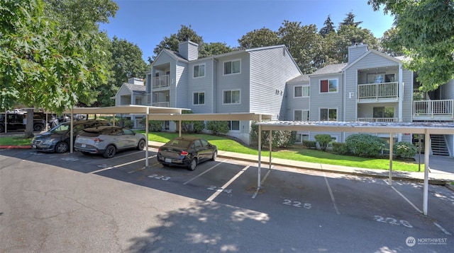 view of car parking with a yard and a carport