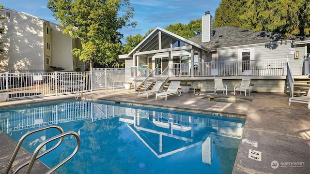 view of swimming pool featuring a wooden deck and a patio