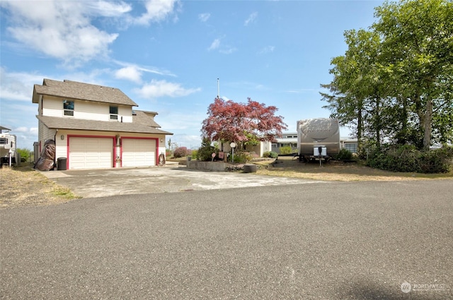 view of front of property featuring concrete driveway and an attached garage