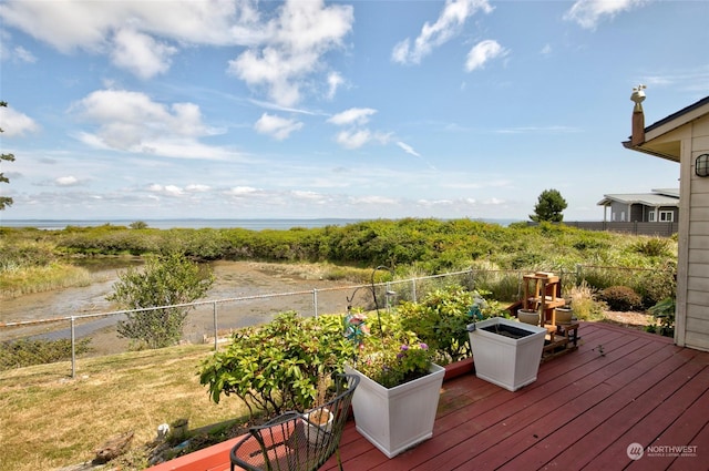 wooden deck with fence and a water view
