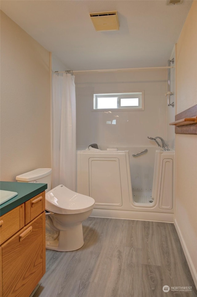 full bath featuring wood finished floors, visible vents, toilet, and vanity