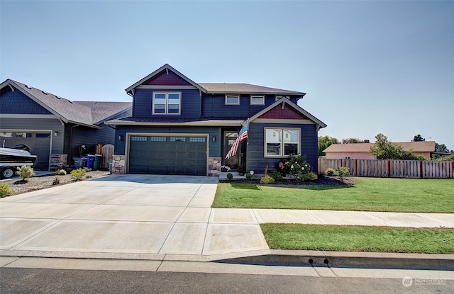 craftsman inspired home featuring a garage and a front yard