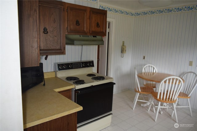 kitchen featuring light countertops, electric range, light floors, and under cabinet range hood