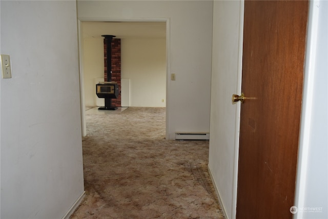 hall with carpet and a baseboard heating unit