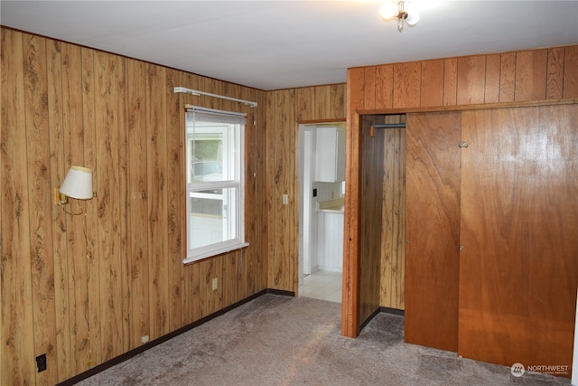 interior space featuring baseboards and wooden walls