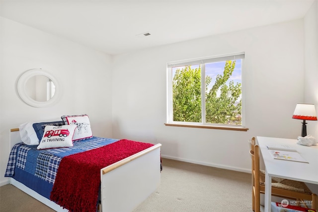 bedroom with light colored carpet