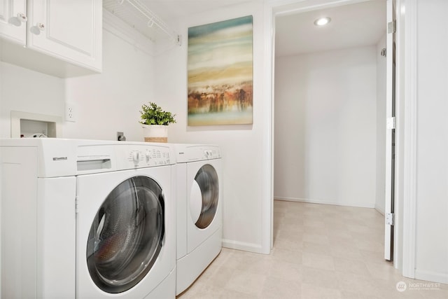 laundry area featuring cabinets and separate washer and dryer