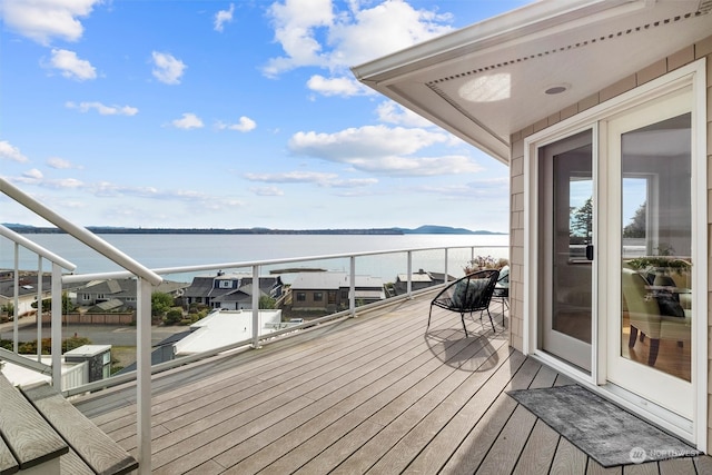 wooden terrace featuring a water view