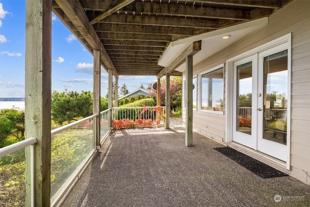 view of patio / terrace with french doors and a water view