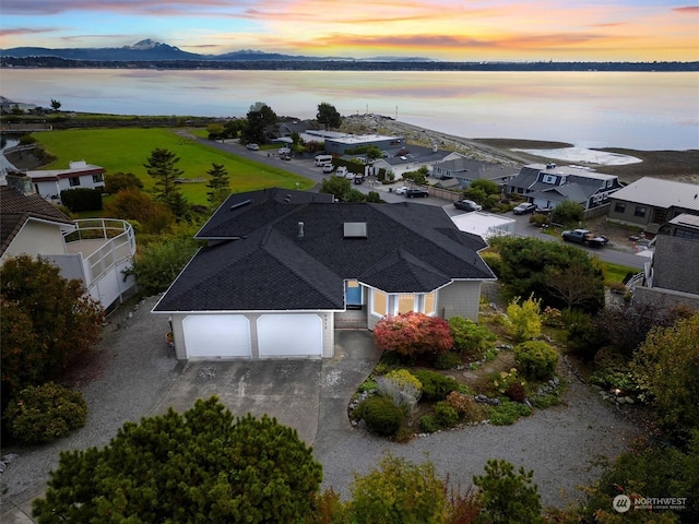 aerial view at dusk with a water and mountain view