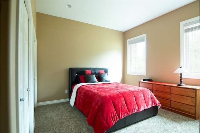 carpeted bedroom featuring multiple windows