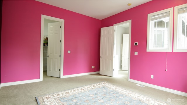 unfurnished bedroom featuring light colored carpet