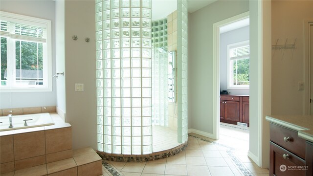 bathroom with tile patterned floors and independent shower and bath