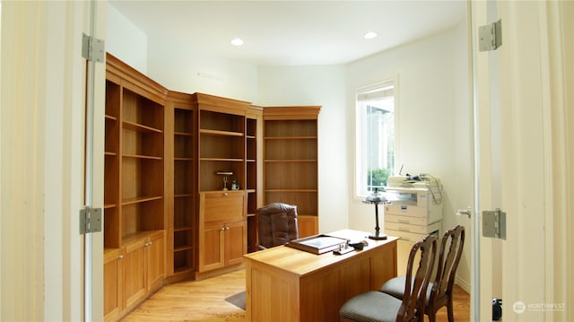 home office with light hardwood / wood-style floors