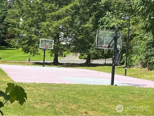 view of basketball court with a lawn