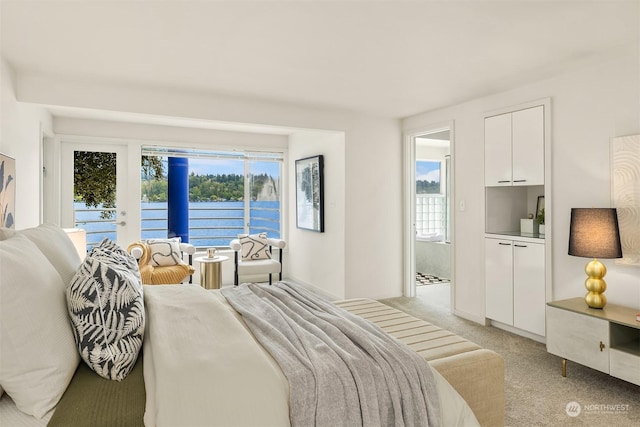 bedroom featuring a water view and light carpet