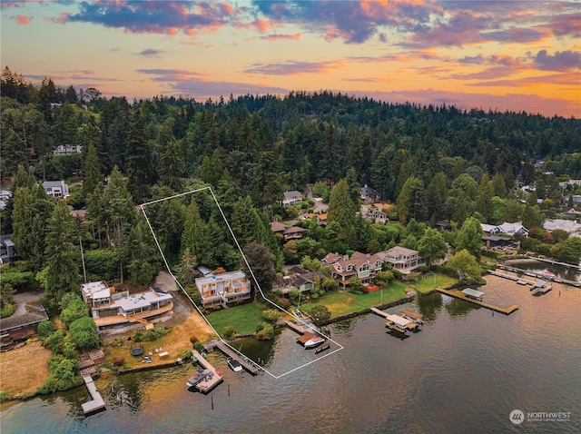 aerial view at dusk with a water view