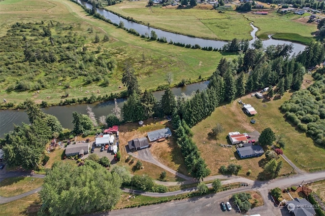 birds eye view of property featuring a water view and a rural view