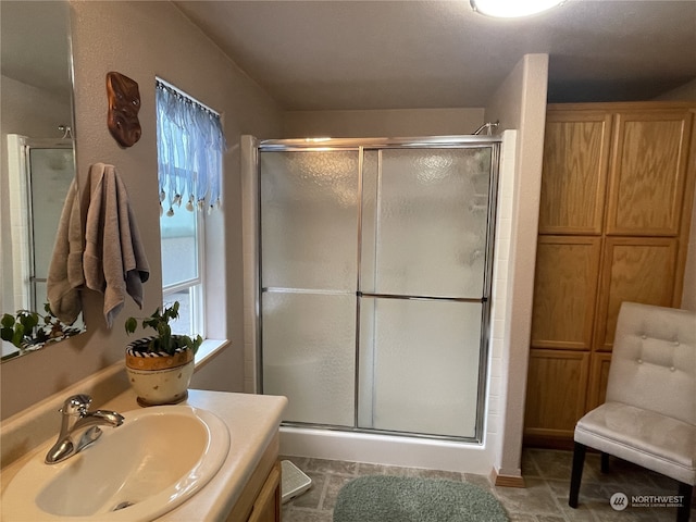 bathroom featuring vanity and an enclosed shower