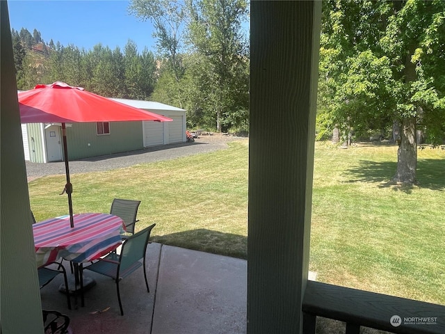 view of yard featuring an outbuilding and a patio area