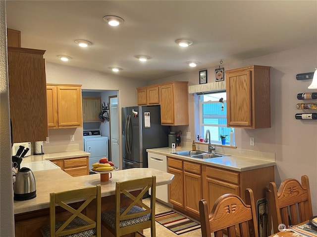 kitchen featuring appliances with stainless steel finishes, sink, and lofted ceiling