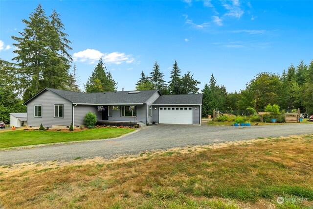 ranch-style house with a front yard and a garage