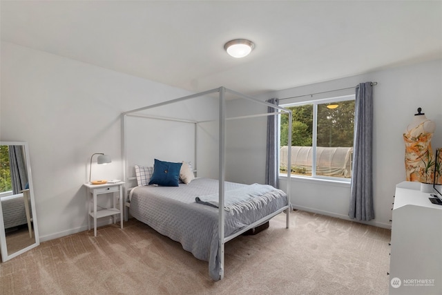 bedroom featuring light colored carpet