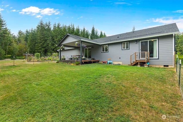 back of house with a lawn